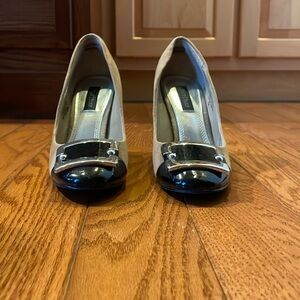 Tan suede with black patent and silver buckle detail at toe  31/2 inch heel.